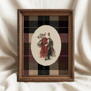 May include: A framed Christmas print featuring Santa Claus carrying a sack of toys. The oval image is set against a plaid background in shades of brown, black, and burgundy. The frame is a dark wood color.