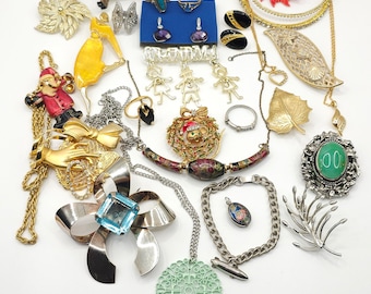 May include: A collection of vintage jewellery including necklaces, earrings, brooches, and rings. The jewellery is made of gold, silver, and other materials. Some of the pieces feature colourful stones and designs.