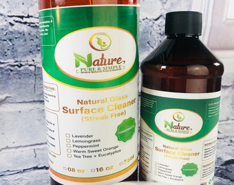 May include: Two amber glass bottles of natural glass surface cleaner with a green label. The label says "Nature, Pure & Simple" and lists the scents: Lavender, Lemongrass, Peppermint, Warm Sweet Orange, Tea Tree + Eucalyptus. The bottles are 8 oz and 16 oz.