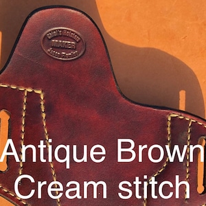 May include: Antique brown leather holster with cream stitching. The holster has a maker's mark that reads "Chief's Holster Maker Jason Fleming".