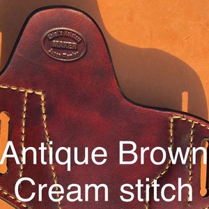 May include: Antique brown leather holster with cream stitching. The holster has a maker's mark that reads "Chief's Holster Maker Jason Fleming".