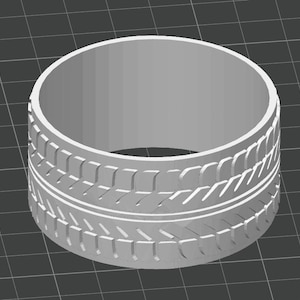 May include: A gray, cylindrical object resembling a tire. The tire has a detailed tread pattern with grooves and ridges. The design is a 3D rendering, with a smooth, matte finish.