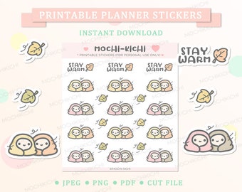 May include: Printable planner stickers featuring two cartoon characters bundled up in blankets with the text "Stay Warm". The stickers are in various colors, including pink, yellow, brown, and beige. There are also images of falling leaves.