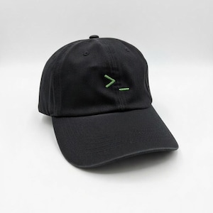May include: Black baseball cap with a curved peak. The cap has a green graphic on the front. The hat is made of a soft material and has a classic, casual style.