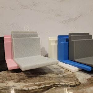 May include: Four different colored plastic organizers, each with three tiers, stacked on top of each other. The colors are black, pink, white, and blue.