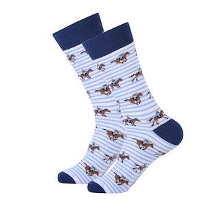 May include: A pair of white socks with blue stripes and a repeating pattern of brown horses with riders. The socks have a navy blue cuff.