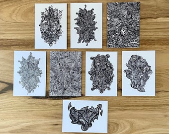May include: Set of eight black and white doodle art prints on white cardstock. Each print features a unique abstract design with intricate details.