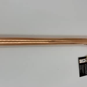 May include: A copper-colored metal rod with a pointed tip and a loop handle. The rod is about 30 inches long. It has a label attached to it that says "It's Time To Shine".