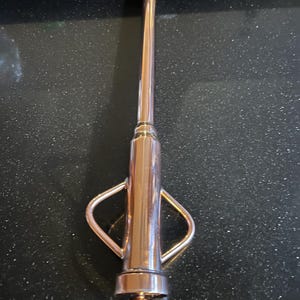 May include: A copper-colored metal oil can with a long spout and two handles. The can has a ring at the bottom.