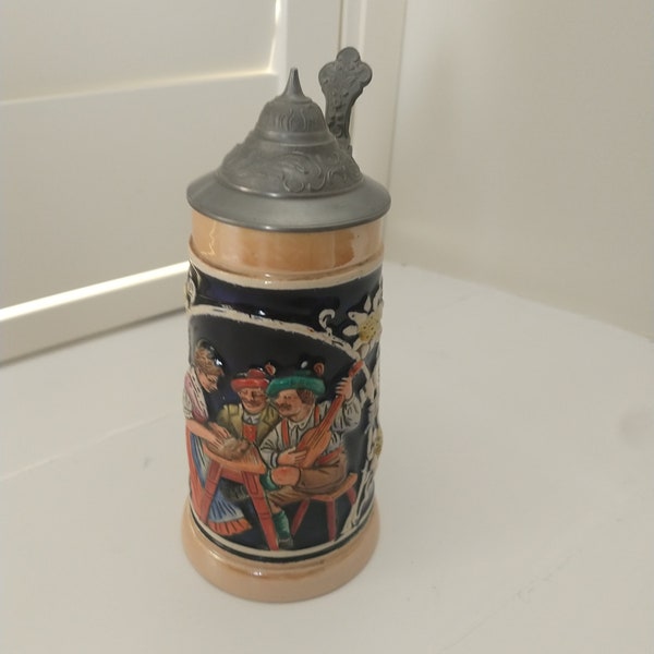 A nice authentic vintage pre 1949 decorative pottery German stein with pewter lid. Decorated with bei Spiel und Sang. Friendship gift.
