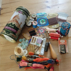 An interesting collection of mainly vintage haberdashery in  Harrods tin. Sewing notions. Anchor thread, bobbins, Newey fastners,Sylko Coats