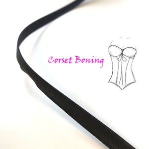 May include: Black corset boning, a flat, flexible strip of material used to shape and support corsets. The boning is shown against a white background. "Corset Boning" is written in pink text.
