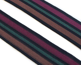 May include: Black, brown, burgundy, and green striped webbing. The webbing is woven with a textured pattern.