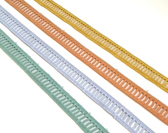 May include: Four different colors of crochet trim with a decorative openwork design. The colors are light green, light blue, peach, and yellow.