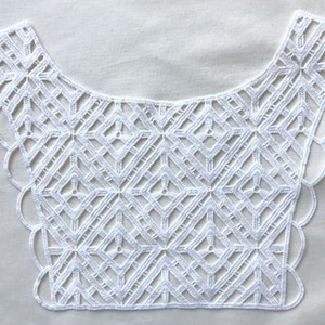 May include: White lace trim with a geometric pattern and scalloped edges. This trim is perfect for adding a touch of elegance to any project.
