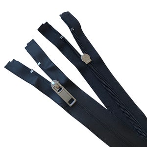 May include: Two black zipper tapes with silver sliders. The zipper tapes are separated and ready to be sewn together.