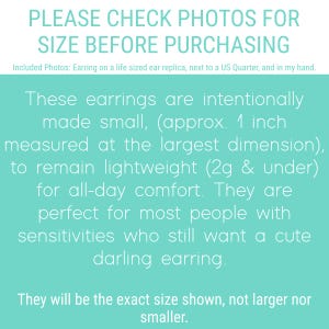 May include: Text on a teal background reads "PLEASE CHECK PHOTOS FOR SIZE BEFORE PURCHASING." The text continues, describing earrings that are approximately 1 inch in size, lightweight, and suitable for sensitive ears.