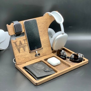 May include: Wooden phone stand with a phone, watch, wallet, sunglasses, and headphones. The stand is personalized with the name "Williams".