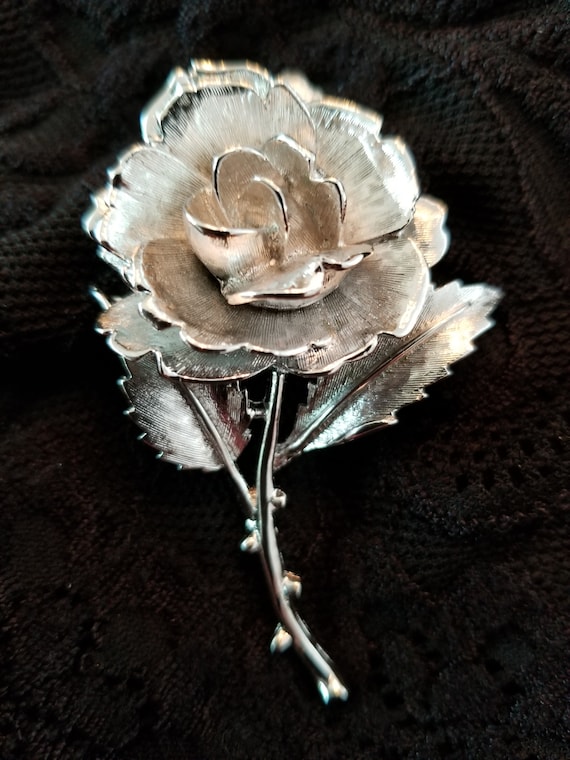 Silvertone metal rose in bloom brooch by Monet