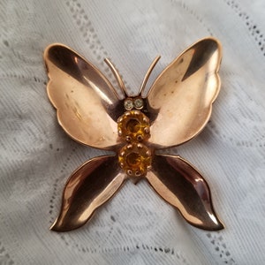 Goldtone butterfly brooch with rhinestone accents