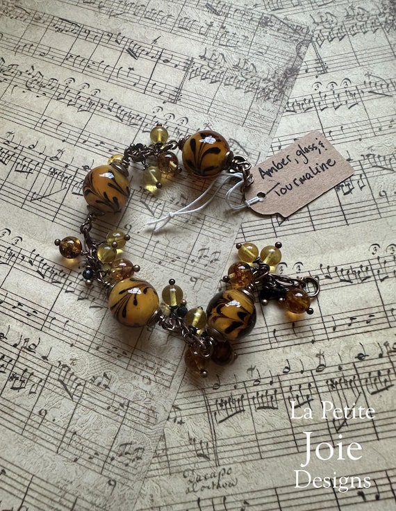 Amber bracelet with honey-colored flowered glass beads and black tourmaline accents