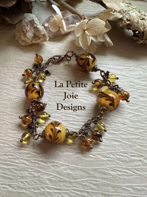 Amber bracelet with honey-colored flowered glass beads and black tourmaline accents