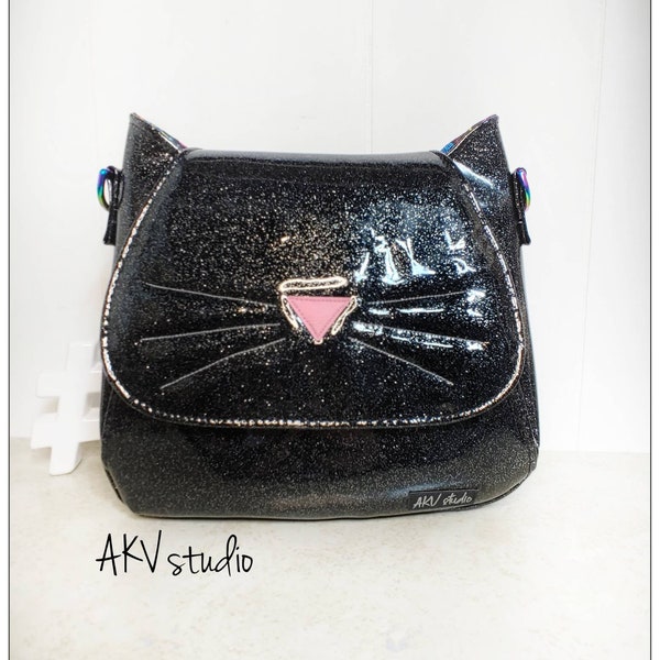 Feline purse. Vinyl exterior. zipper pocket. Adjustable strap. The Dinah bag. Catsiopeia pattern. Read item details