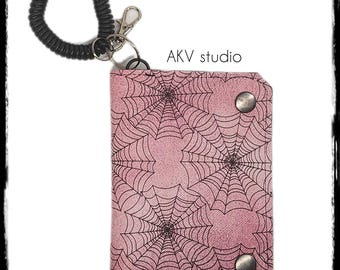 Pink Spiderweb Brooke Bifold Wallet. Card slots. zipper coin pocket. Wristlet. Keychain. Scroll down to read item details.