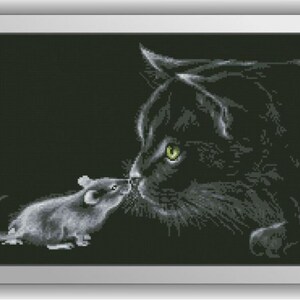 May include: A black cat with green eyes looks at a small gray mouse. The cat and mouse are nose to nose, and the background is black.