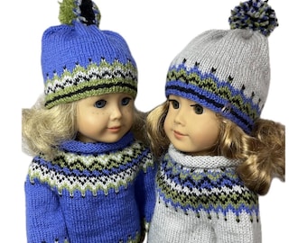 May include: A PDF knitting pattern for a sweater and cap sized for 18 inch dolls. The image shows two dolls wearing matching knitted sweaters and caps featuring a blue, green, white, and black geometric pattern with a pom-pom on each cap.