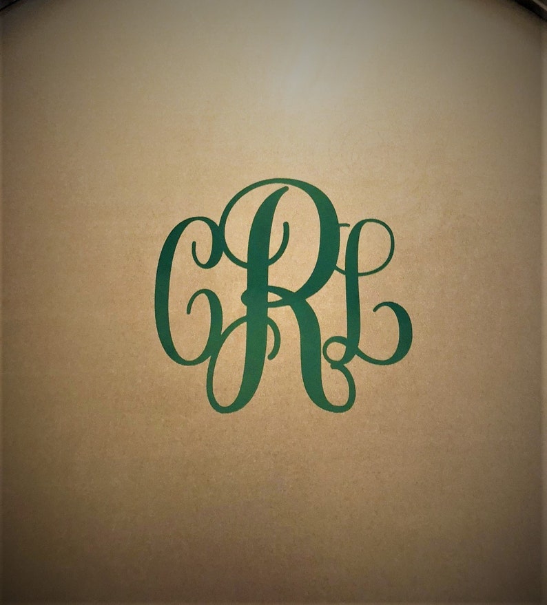 Puede incluir: Un monograma verde con las letras "CRL" en una fuente cursiva.