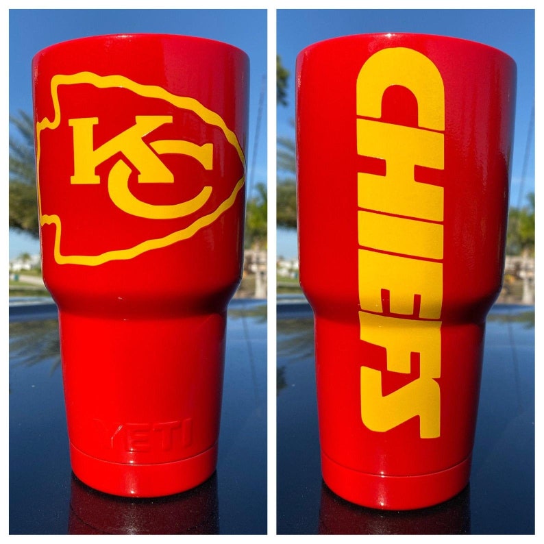 May include: A red and yellow insulated tumbler with the Kansas City Chiefs logo on one side and the word "Chiefs" on the other side.