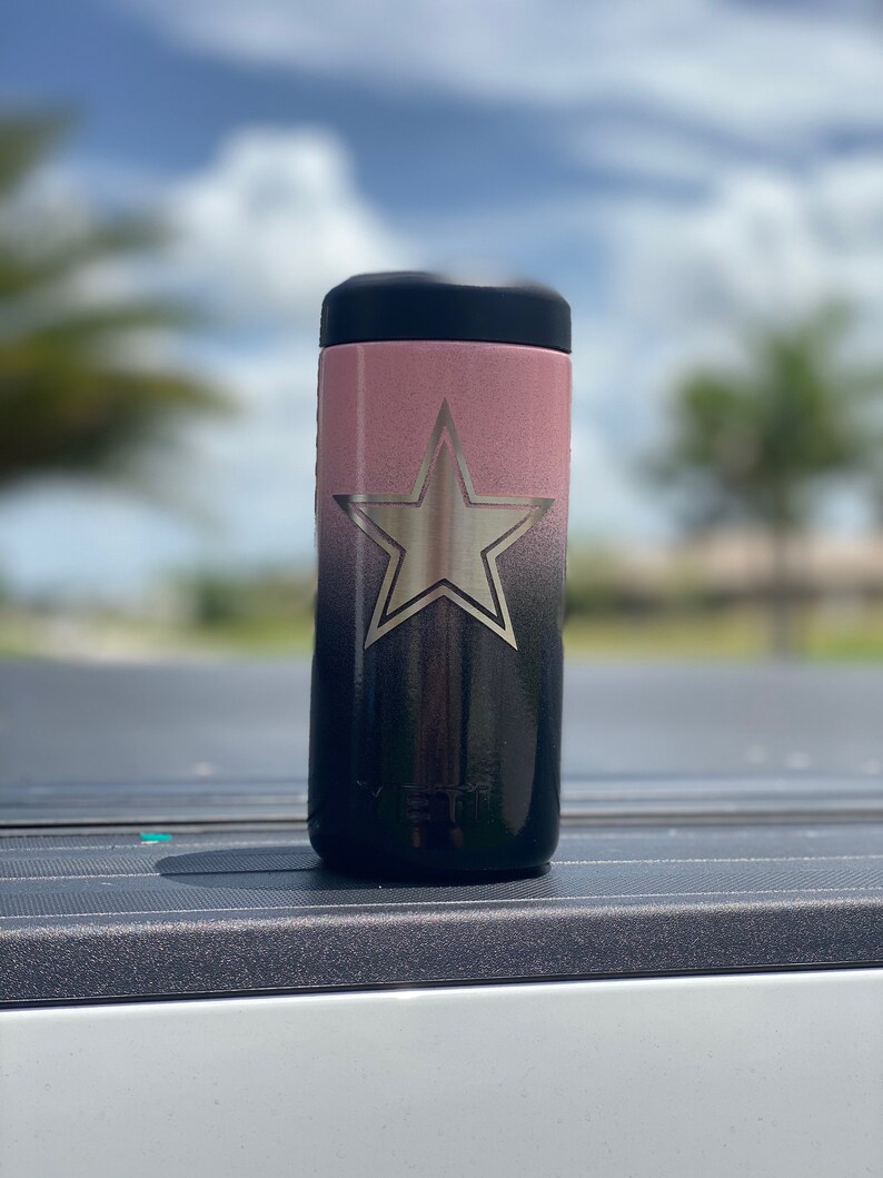 May include: A black and pink stainless steel tumbler with a silver star design. The tumbler has a black lid and a black base.