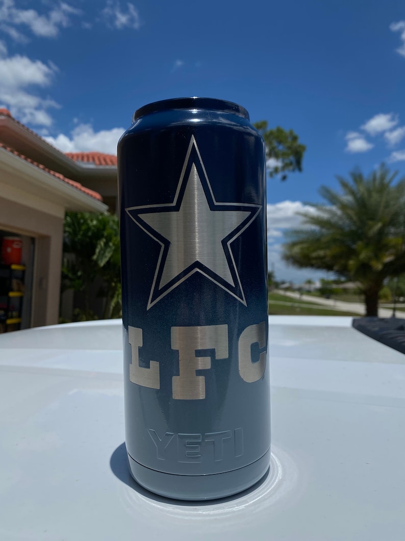 May include: A blue and gray Yeti Rambler with a silver star and the letters "LFC" on the side.