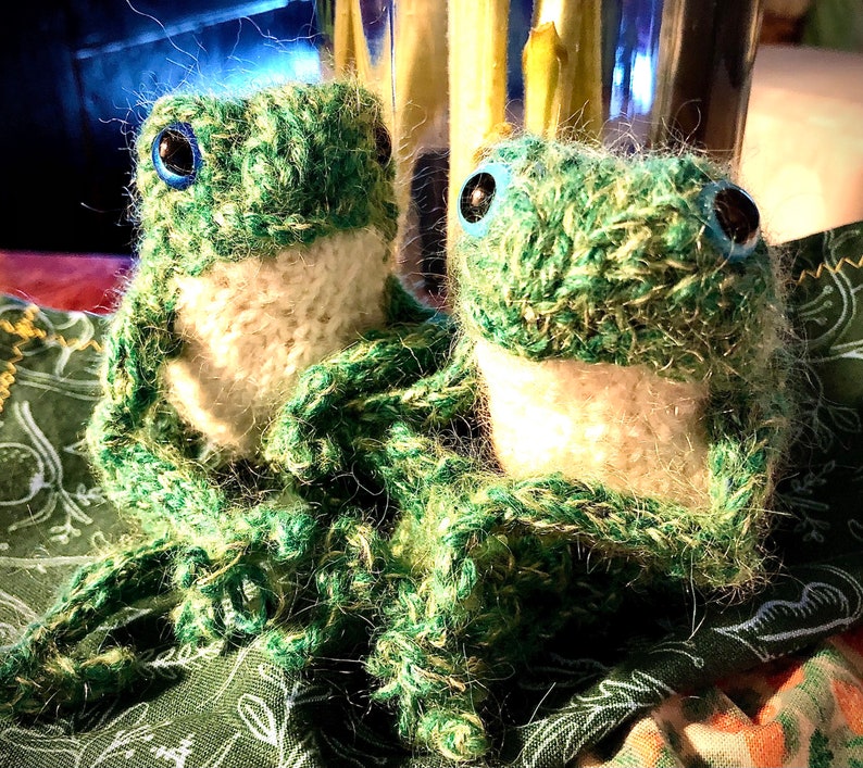 little knitted frog green, or blue-green, or olive or purple green frog