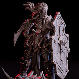 May include: A dark gray, detailed miniature figurine of a female warrior with a shield, sword, and braided hair. The figurine is standing on a rocky base with spikes.