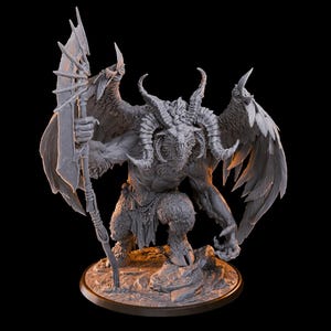 May include: A gray figurine of a horned, winged creature with a spear. The figure has a goat-like face, muscular arms, and feathered wings. It stands on a rocky base with a dark background. The spear is held in its right hand.
