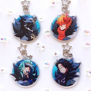 May include: Four round, clear acrylic keychains with colorful anime characters. Each keychain features a different character with black hair and a black and white feathered collar. The characters are set against a blue background.