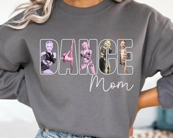 May include: Gray sweatshirt with the text "Dance Mom" in white. The text is surrounded by images of dancers in various poses.