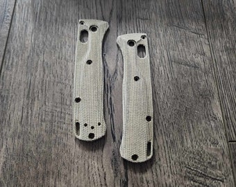 May include: Two beige knife scales with a textured pattern and multiple holes. The scales are made of G10 material and are compatible with Benchmade knives.