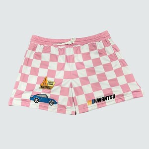 May include: Pink and white checkered shorts with a blue car and a yellow "Cozy Cone Motel" sign embroidered on the front. The shorts have a black "IHWANTSU" logo on the right leg.