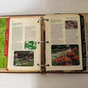 May include: Open vintage binder with pages about gardening. The left page has a green chart with text: "Is it a weed or a flower? Annual flower seedlings identified." The right page has text and photos about lilies and plant hardiness.