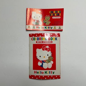 May include: Two Hello Kitty coloring books. The top book is red with white polka dots and says "Coloring Stickers" with 24 stickers. The bottom book is red with white polka dots and says "Coloring Book with Stickers". Both books feature Hello Kitty and a bear.
