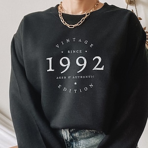 May include: Black sweatshirt with white text that reads "Vintage Since 1992 Aged & Authentic Edition".