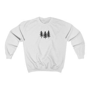 May include: White sweatshirt with a black silhouette of three pine trees on the front.