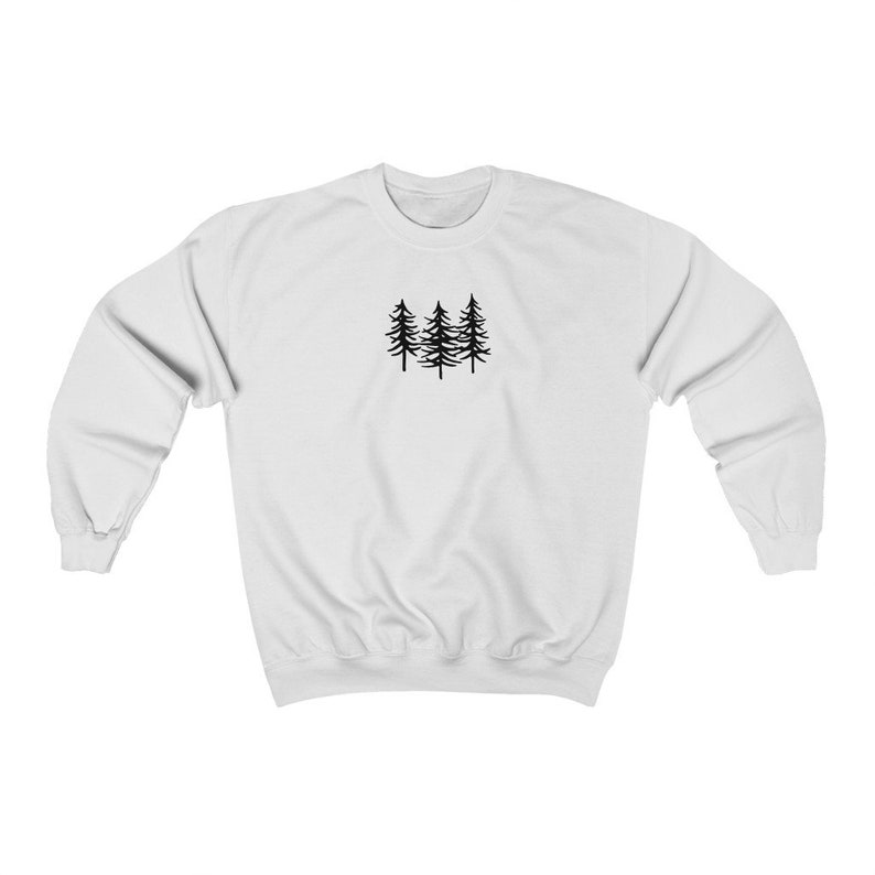 May include: White sweatshirt with a black silhouette of three pine trees on the front.