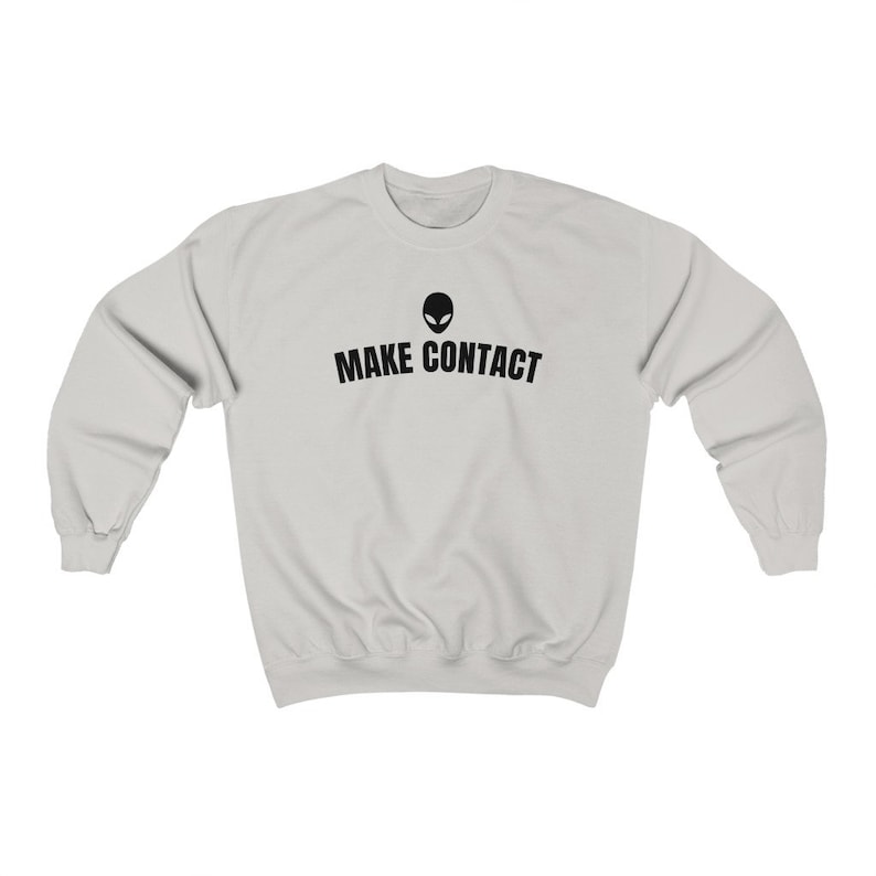May include: A light gray sweatshirt with a black alien head graphic and the text "MAKE CONTACT" printed on the front.