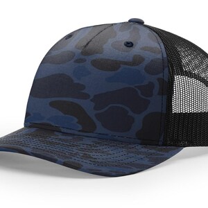 May include: A blue camouflage trucker hat with a black mesh back. The hat features a curved brim and a button on top. The camouflage pattern includes shades of blue and black.
