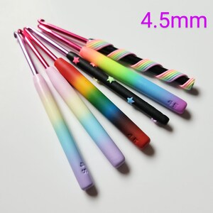 May include: Set of seven 4.5 mm crochet hooks with rainbow ombre handles. Each hook has a star charm and is labeled with the size 4.5.