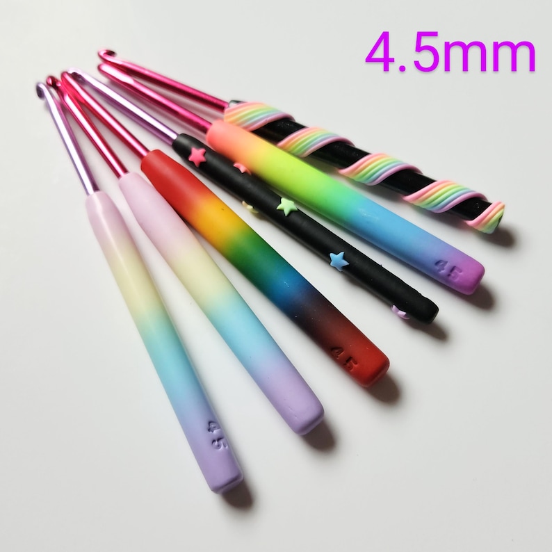 May include: Set of seven 4.5 mm crochet hooks with rainbow ombre handles. Each hook has a star charm and is labeled with the size 4.5.